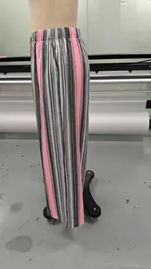 Side view of stylish pink and gray vertical striped wide-leg trousers on a mannequin