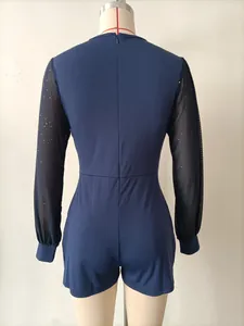 Rückansicht eines marineblauen Jumpsuits mit glitzernden schwarzen Netzärmeln für Damen