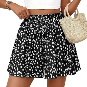 Detail of women's high-waisted black spotted A-line shorts with drawstring and elastic waist