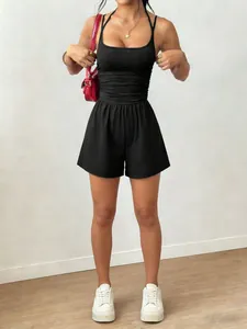 Close-up of a black sleeveless halter romper with cinched waist and relaxed wide-leg shorts