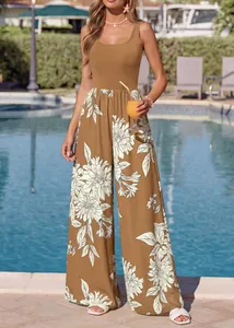 Detail view of a brown sleeveless floral wide-leg jumpsuit in a summer resort setting
