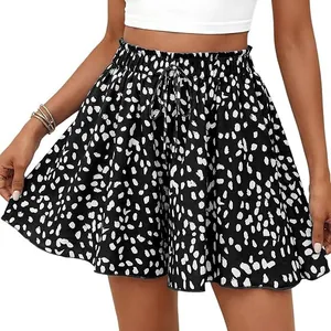 Close-up of black and white spotted high-waisted A-line shorts with adjustable drawstring