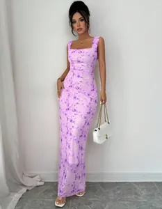 Full length view of elegant purple floral slim fit maxi dress worn by Asian model