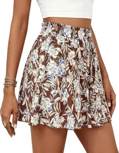 Detail view of high-waisted floral A-line shorts with an elastic ruffled waistband.