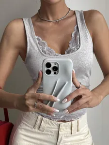Nahaufnahme eines grauen, eng anliegenden Tanktops mit eleganter weißer Spitze am Saum.