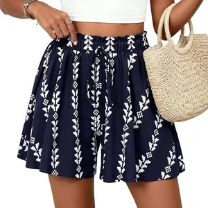 Detailed view of high-waisted A-line shorts featuring navy geometric print and drawstring
