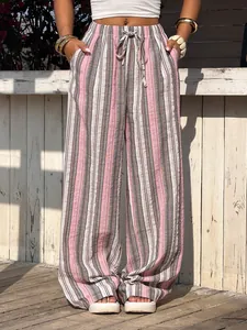 High-waisted pink and grey striped wide-leg trousers featuring a drawstring waist detail