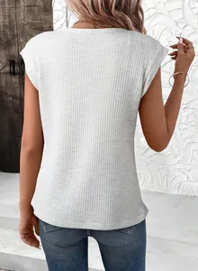 Detailed back view of a white waffle knit crewneck short sleeve loose women's top.