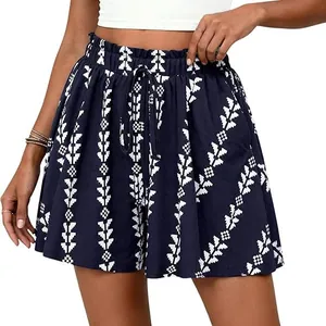 Detail view of navy blue high-waisted A-line shorts featuring a white tribal pattern