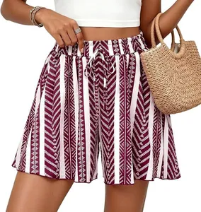 Detail view of women's high-waisted A-line shorts with burgundy geometric print pattern.