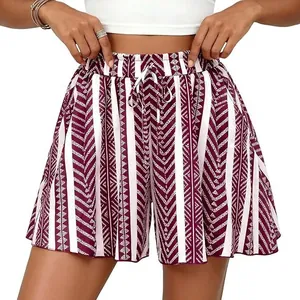 Close-up view of high-waisted A-line shorts featuring wine red geometric patterns and drawstring.