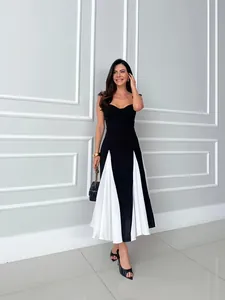 Elegant French style black and white color-block midi dress with a pleated hem detail.