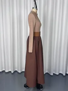 Side profile of a Hepburn style French long sleeve knit top and maxi skirt on a mannequin.