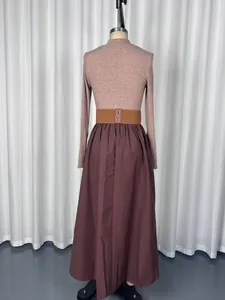 Detailed back view of an elegant French Hepburn style long-sleeve maxi dress with belt