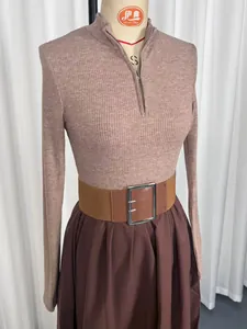 Close-up of French style mauve ribbed knit top with brown wide belt and pleated skirt
