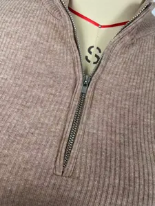 Detail of the quarter-zip collar and ribbed knit texture on a French style dress