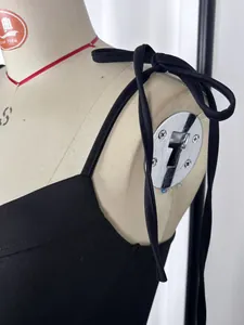 Detail of adjustable tie-up shoulder straps on an elegant black French style camisole dress