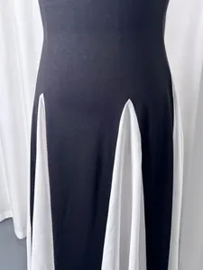 Detail of French elegant black and white color-blocked dress with pleated hem design