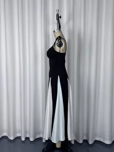 Detailed side view of French style elegant black and white contrast slit long dress