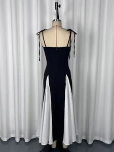 Back view of elegant black and white color-block maxi dress with tie straps