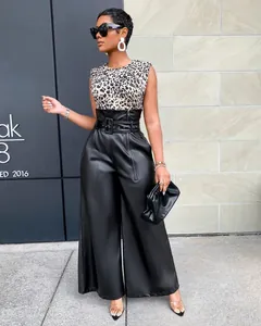 Model wearing high-waisted black PU leather wide-leg pants with a stylish matching belt