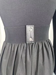 Close-up detail showing the black elastic waist belt and metal buckles on a French style dress.
