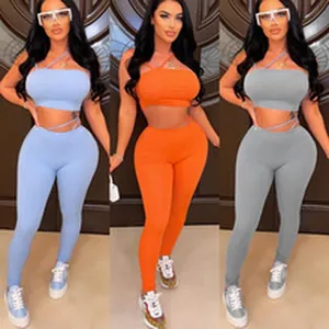 Women's two-piece sports set with crop top and leggings in blue, orange, and grey