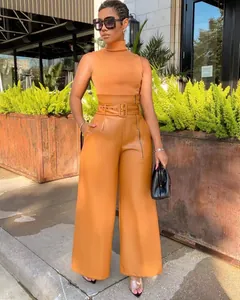 Full length view of chic high waist orange PU leather wide leg pants with belt