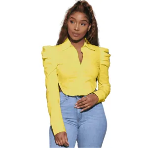 Fashionable yellow long-sleeved shirt for women with puffed shoulders and waist cutout detail