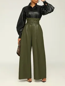 Close-up detail of high waist olive green faux leather pants featuring a metal belt