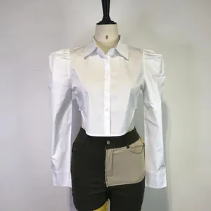 Stylish white puff sleeve shirt featuring a trendy cropped waist design on a mannequin