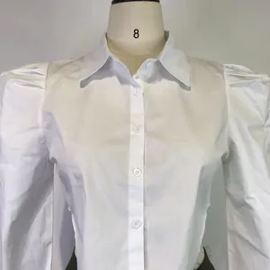 Detailed view of a white long-sleeved lapel shirt featuring elegant puff shoulders.