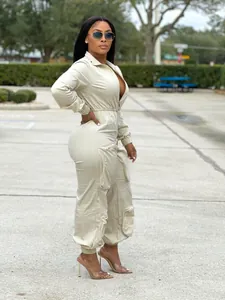 Full view of women's beige waist-cinching cargo jumpsuit with metal zipper details