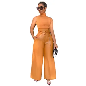 Model wearing camel high-waisted PU leather wide-leg pants with belt and matching top