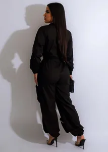 Rear view detail of a black cinched waist cargo jumpsuit featuring elastic cuffs and hems