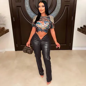 Full view of model wearing black low waist V-cut faux leather cargo pants with pockets.