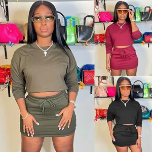 Women's casual two-piece set featuring a long sleeve crop top and drawstring skirt.