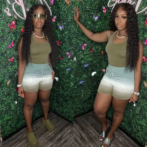 Full body view of model wearing two-piece olive tank top and gradient shorts set
