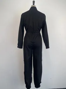 Back view of black long-sleeved utility jumpsuit with cinched waist design for women