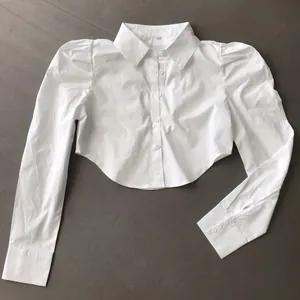 Elegant white cropped long sleeve shirt with puff sleeves and pointed collar detail