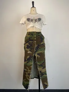 Distressed camouflage maxi skirt with high slit and functional cargo pockets.