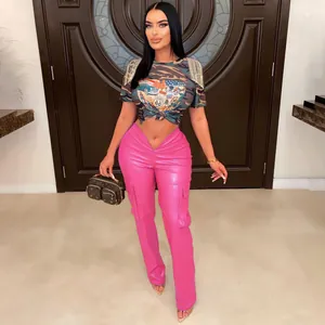 Close-up of pink PU leather cargo pants with pockets and camo t-shirt on a model