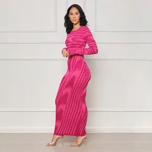 Full-length side view of a slim model in a pink irregular print bodycon long sleeve dress