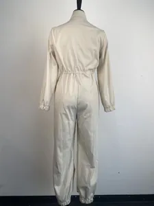 Back view of women's beige utility jumpsuit featuring a cinched elastic waist design