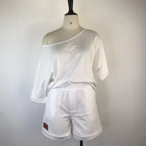 Close-up of white two-piece loungewear set with off-shoulder top and matching shorts