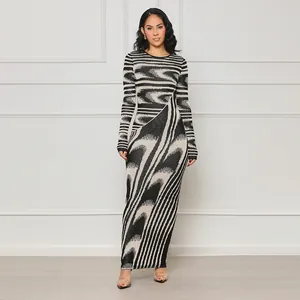Full body view of a slim-fit maxi dress with irregular abstract print and long sleeves.