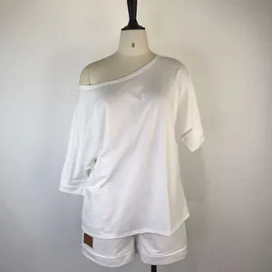 Detail view of a white off-the-shoulder two-piece loungewear set on a mannequin