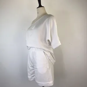 Side view of a white off-shoulder sweatshirt and shorts two-piece lounge set on a mannequin