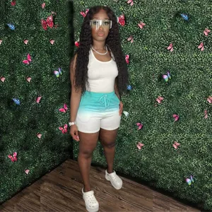 Full view of women's trendy white tank top and teal gradient shorts set.