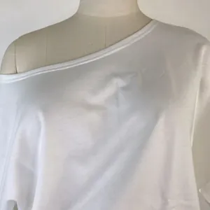 Close-up detail of the white one-shoulder sweatshirt neckline shown on a mannequin torso
